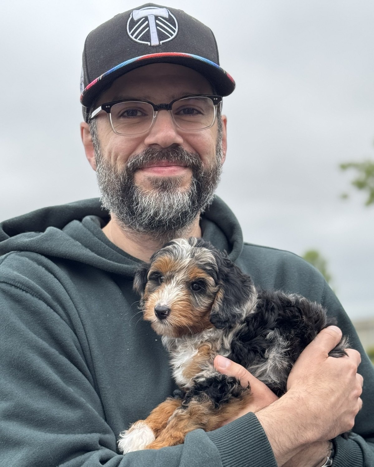 Rick Reyes, Founding Pastor, holding his puppy Gracie